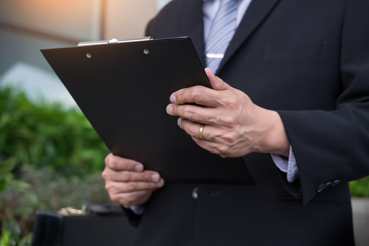 businessman holding a clipboard for working in outdoor Lawyer pointing to legal documents