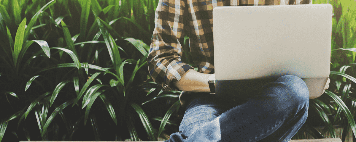 Remote worker on a laptop sitting outside