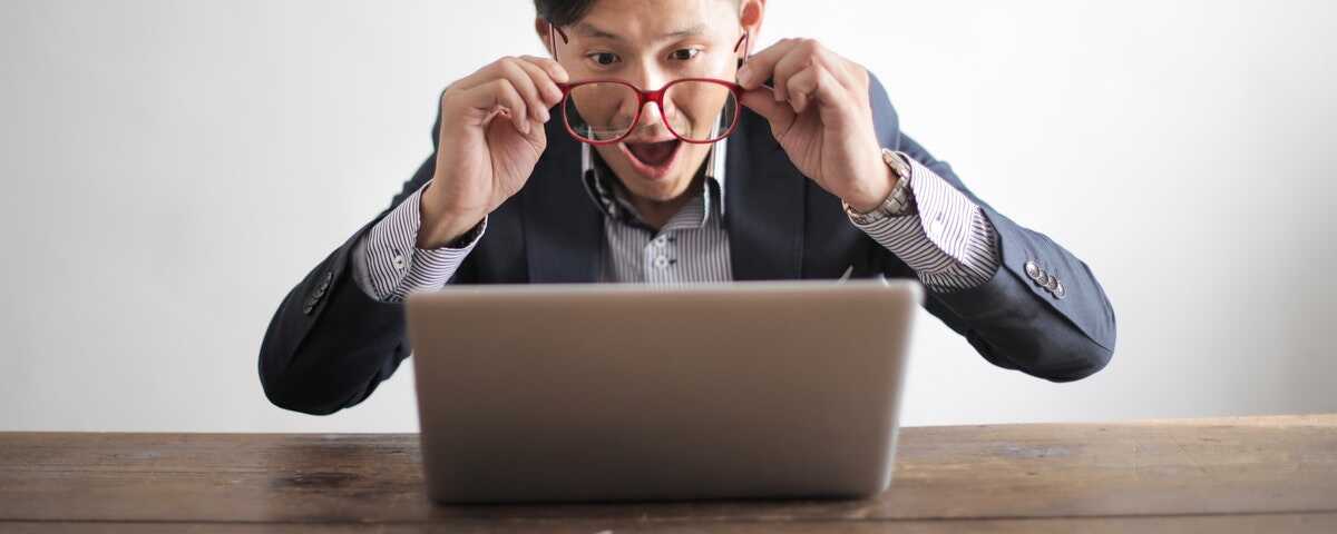 A man stares amazed at his laptop