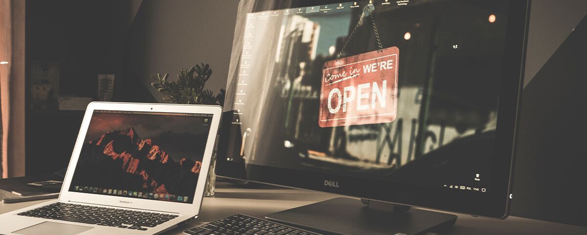 Computer monitor with a "come in we're open" sign